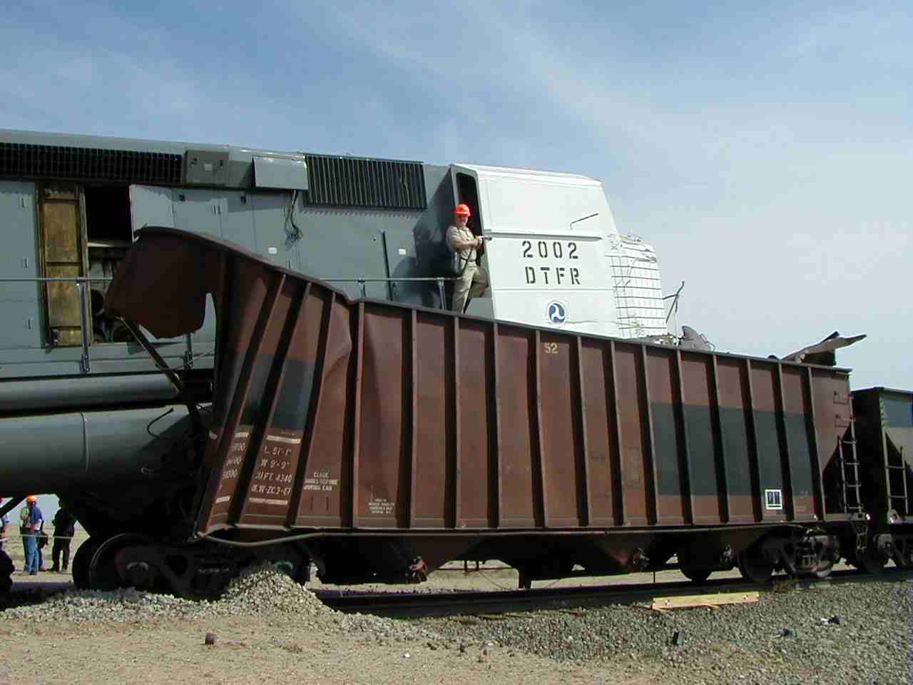 Locomotive resting on hopper cars.